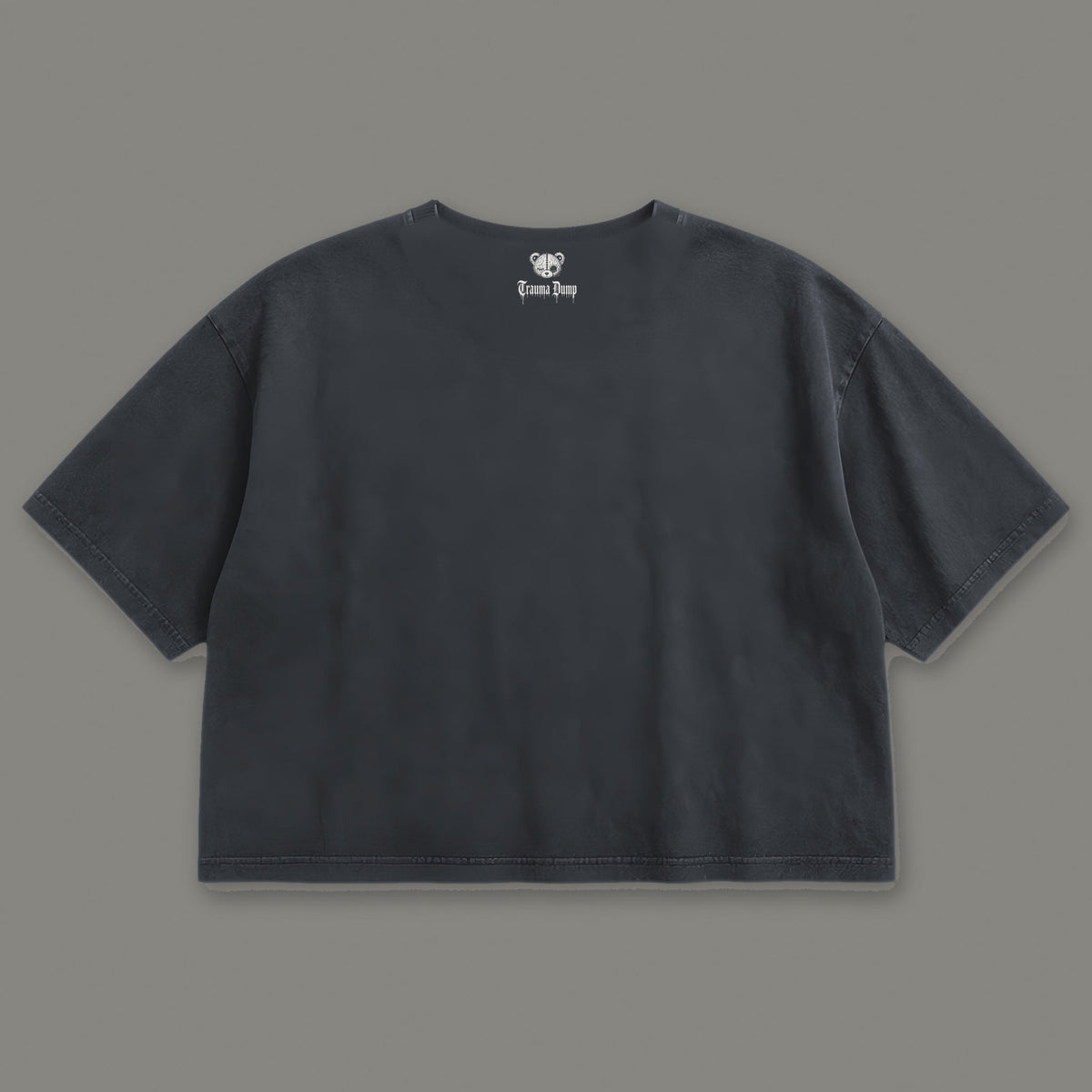 Inner Child Cropped Baby Tee in black, back view with Trauma Dump bear-head logo under the collar