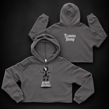 People Pleaser Cropped Hoodie by Trauma Dump, goth cropped hoodie with cut-strings marionette print, mockup view 2 (Storm, white ink)