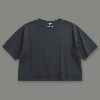 Inner Child Cropped Baby Tee in black, back view with Trauma Dump bear-head logo under the collar