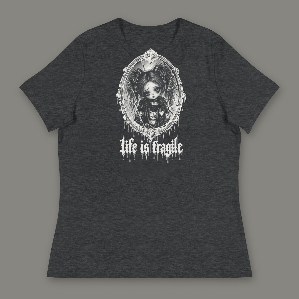 Life is Fragile Women's Relaxed Tee in dark grey heather by Trauma Dump, white-ink print of young Wren in a cracked oval mirror frame with dripping "life is fragile" lettering (Dark Grey Heather, white ink)