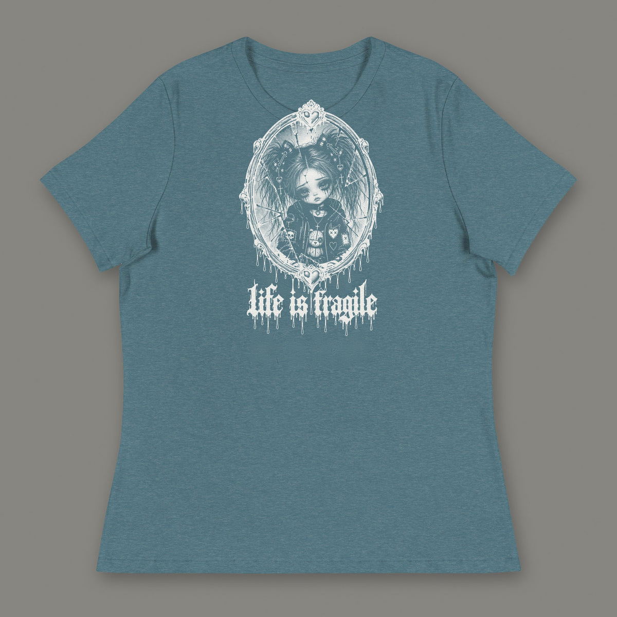 Life is Fragile Women's Relaxed Tee in heather deep teal by Trauma Dump, white-ink print of young Wren in a cracked oval mirror frame with dripping "life is fragile" lettering (Heather Deep Teal, white ink)