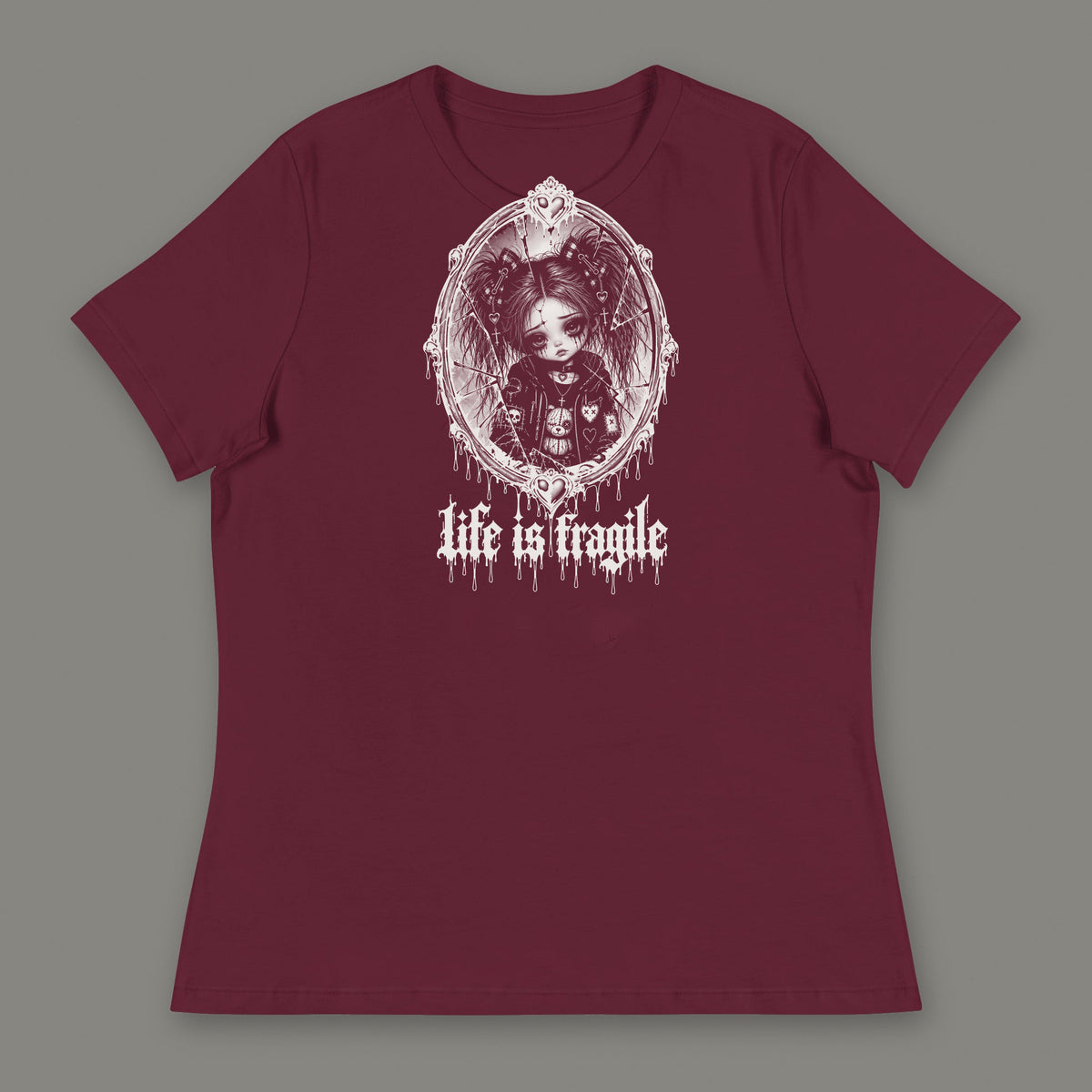 Life is Fragile Women's Relaxed Tee in maroon by Trauma Dump, white-ink print of young Wren in a cracked oval mirror frame with dripping "life is fragile" lettering (Maroon, white ink)