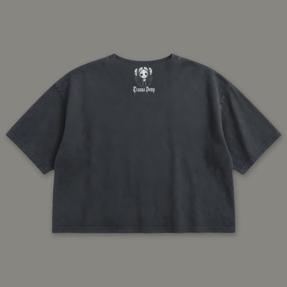 People Pleaser Cropped Baby Tee in black, back view with doll portrait logo under the collar