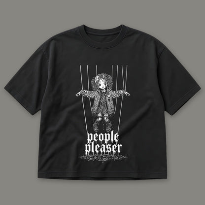 People Pleaser Women's Boxy Tee in black by Trauma Dump, cut-string marionette tattoo-style gothic graphic (Black, white ink)