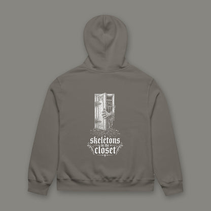 Skeletons in the Closet Oversized Heavyweight Hoodie by Trauma Dump, oversized goth hoodie with skeleton hand print, mockup view 3 (Asphalt, white ink)