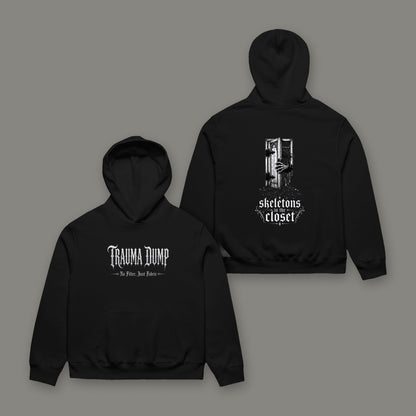 Skeletons in the Closet Unisex Oversized Heavyweight Hoodie in black by Trauma Dump, front with TD logo and back with skeletons graphic in white ink (Black, white ink)
