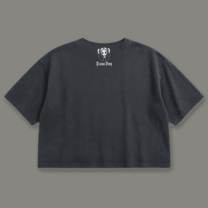 Skeletons in the Closet Cropped Baby Tee in black, back view with doll portrait logo under the collar