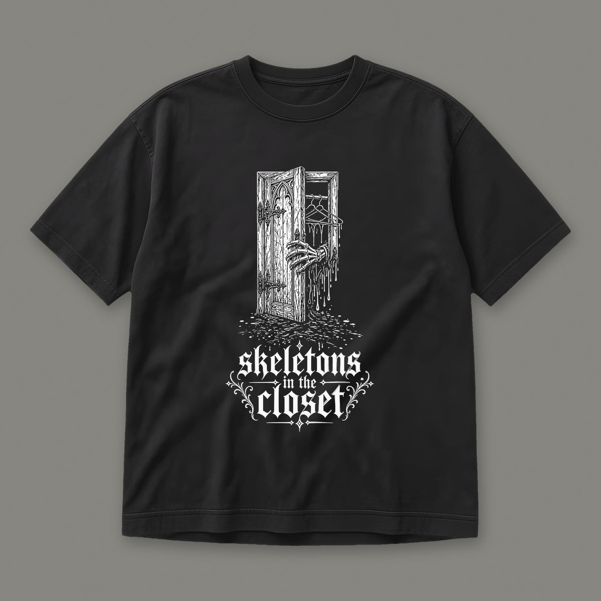 Skeletons in the Closet Men's Heavyweight Tee in black by Trauma Dump, skeleton hand in a closet door tattoo-style gothic graphic in white ink (Black, white ink)