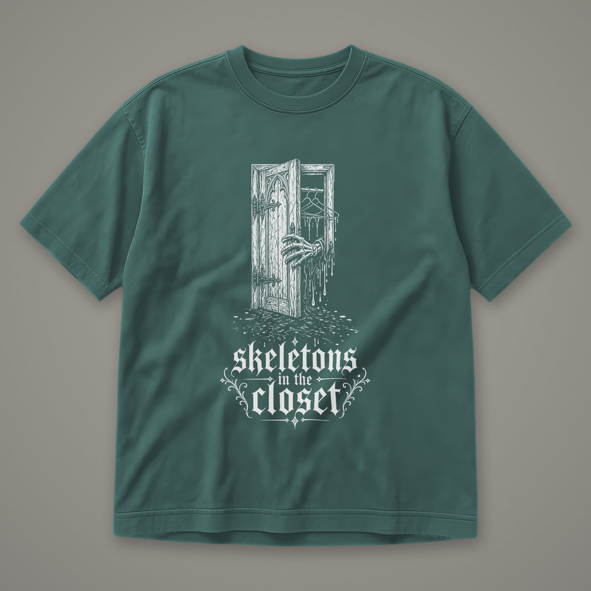 Skeletons in the Closet Men's Heavyweight Tee in blue spruce by Trauma Dump, skeleton hand in a closet door tattoo-style gothic graphic in white ink (Blue Spruce, white ink)