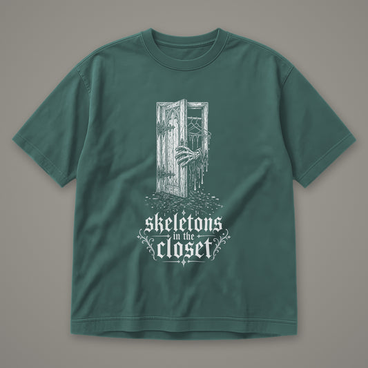 Skeletons in the Closet Men's Heavyweight Tee in blue spruce by Trauma Dump, skeleton hand in a closet door tattoo-style gothic graphic in white ink (Blue Spruce, white ink)