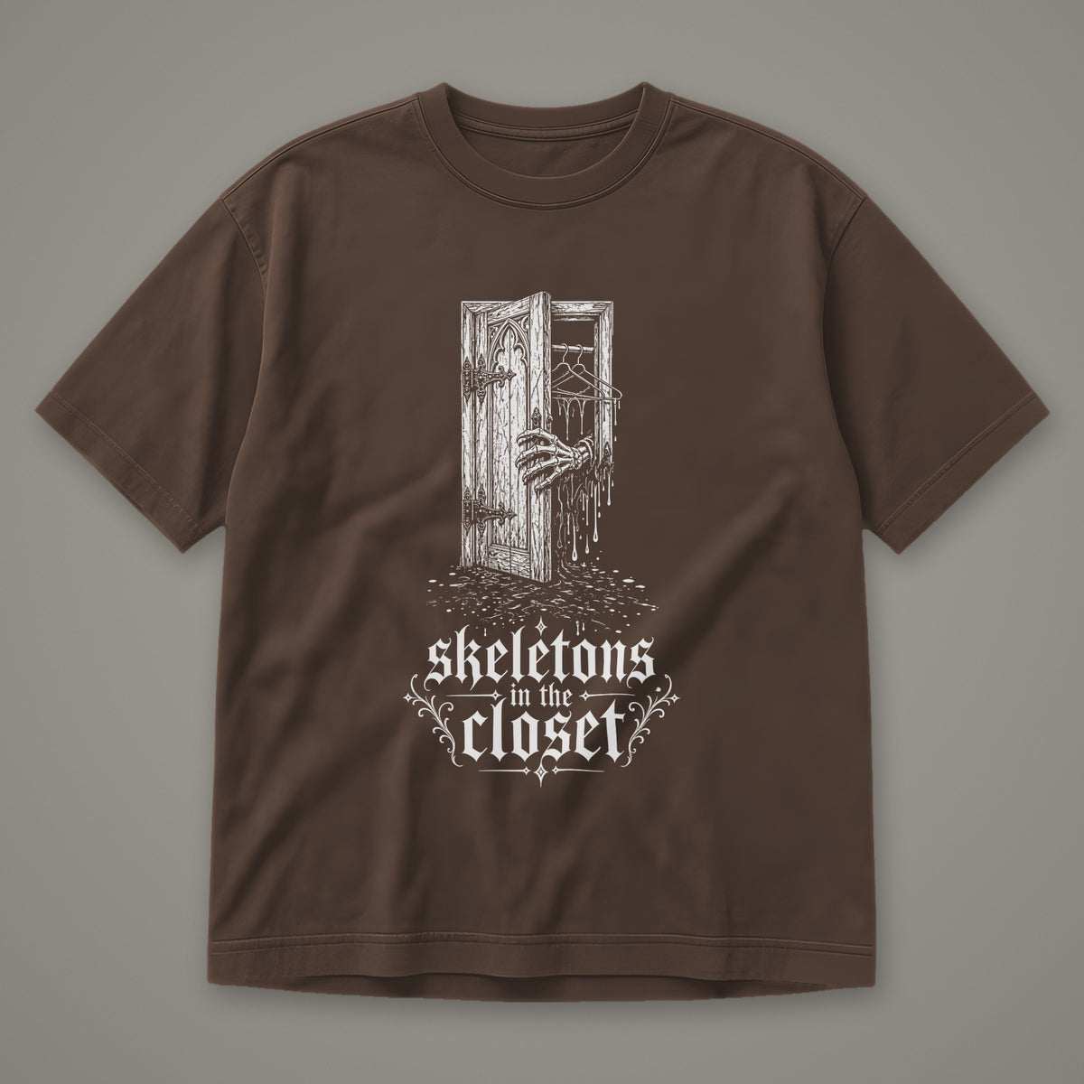 Skeletons in the Closet Men's Heavyweight Tee in espresso by Trauma Dump, skeleton hand in a closet door tattoo-style gothic graphic in white ink (Espresso, white ink)