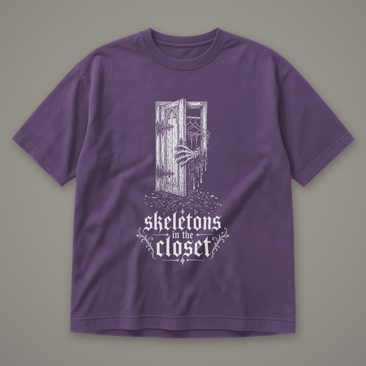 Skeletons in the Closet Men's Heavyweight Tee in grape by Trauma Dump, skeleton hand in a closet door tattoo-style gothic graphic in white ink (Grape, white ink)