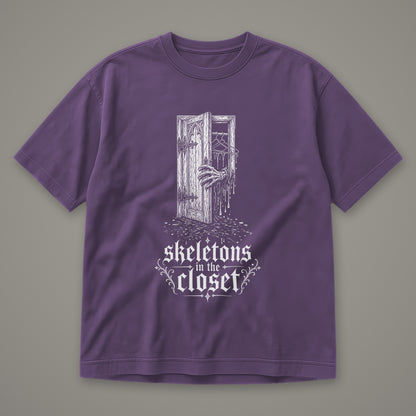 Skeletons in the Closet Men's Heavyweight Tee in grape by Trauma Dump, skeleton hand in a closet door tattoo-style gothic graphic in white ink (Grape, white ink)