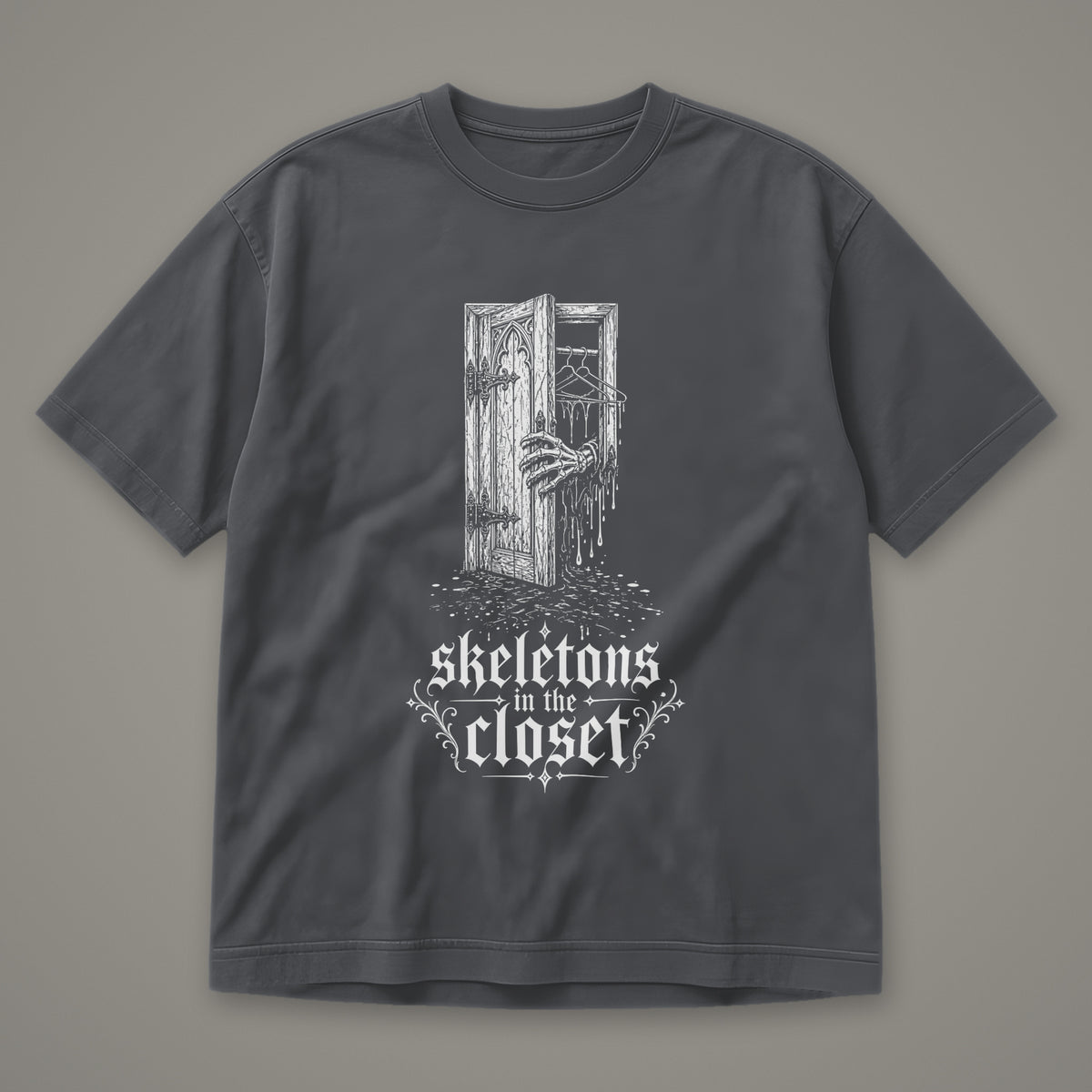 Skeletons in the Closet Men's Heavyweight Tee in graphite by Trauma Dump, skeleton hand in a closet door tattoo-style gothic graphic in white ink (Graphite, white ink)