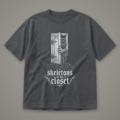 Skeletons in the Closet Men's Heavyweight Tee in graphite by Trauma Dump, skeleton hand in a closet door tattoo-style gothic graphic in white ink (Graphite, white ink)