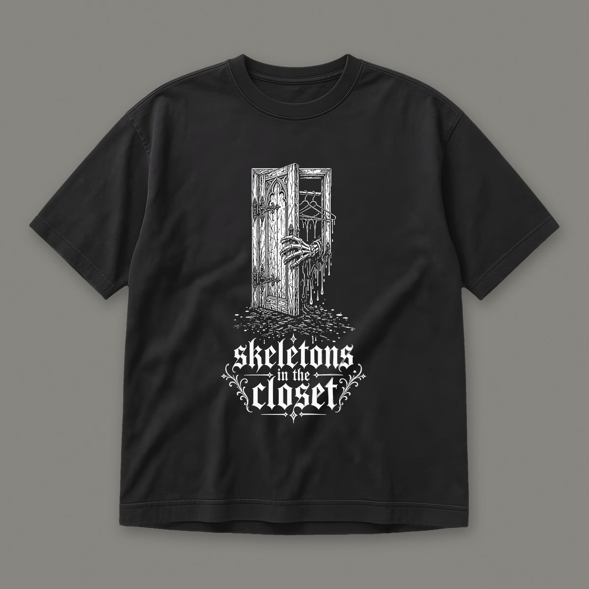 Skeletons in the Closet Men's Heavyweight Tee in black by Trauma Dump, skeleton hand in a closet door tattoo-style gothic graphic (Black, white ink)
