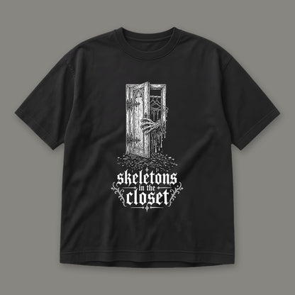 Skeletons in the Closet Men's Heavyweight Tee in black by Trauma Dump, skeleton hand in a closet door tattoo-style gothic graphic (Black, white ink)