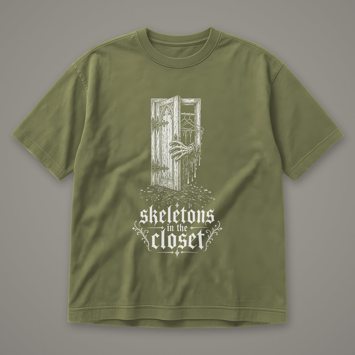 Skeletons in the Closet Men's Heavyweight Tee in moss by Trauma Dump, skeleton hand in a closet door tattoo-style gothic graphic in white ink (Moss, white ink)