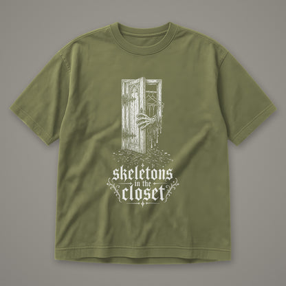 Skeletons in the Closet Men's Heavyweight Tee in moss by Trauma Dump, skeleton hand in a closet door tattoo-style gothic graphic in white ink (Moss, white ink)