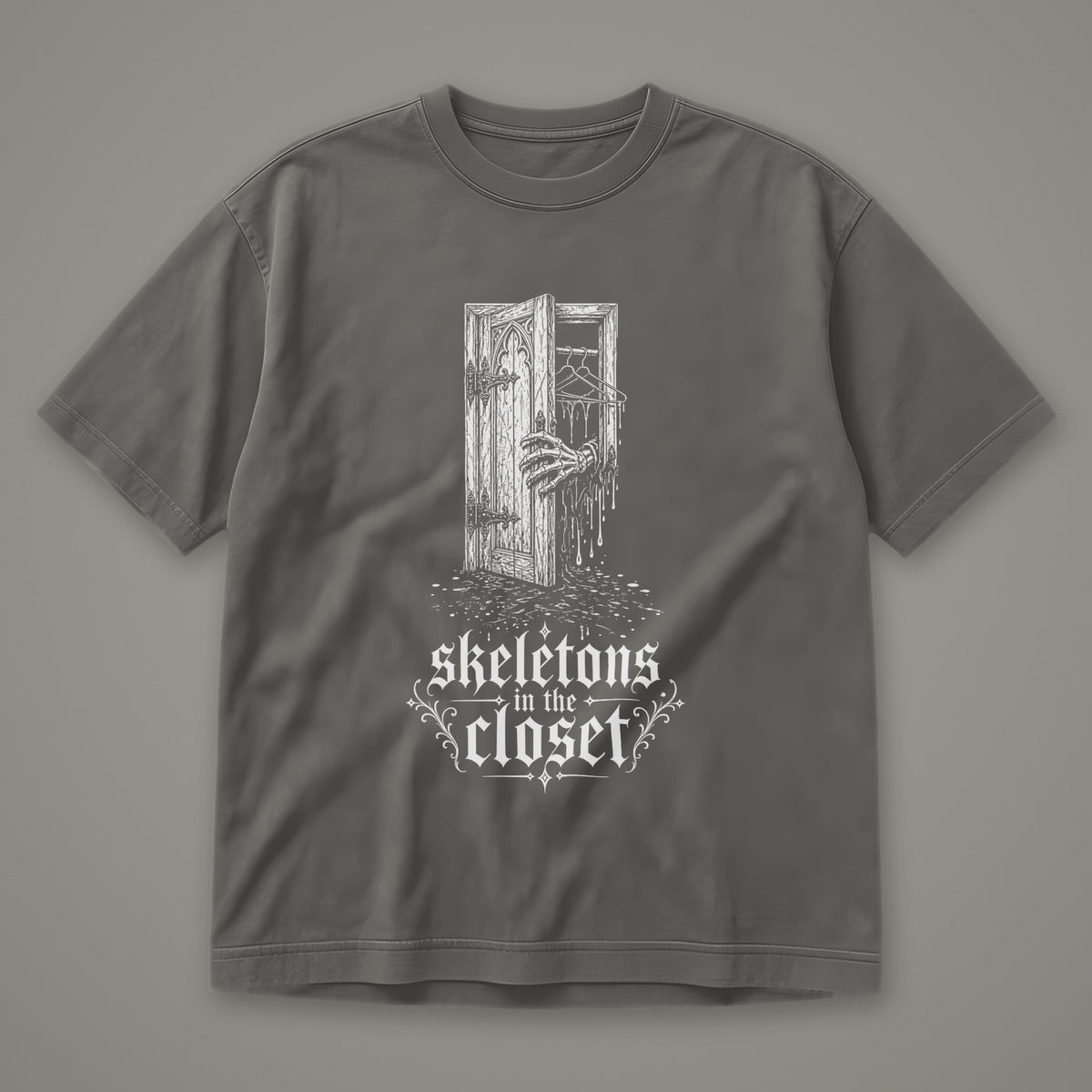 Skeletons in the Closet Men's Heavyweight Tee in pepper by Trauma Dump, skeleton hand in a closet door tattoo-style gothic graphic in white ink (Pepper, white ink)