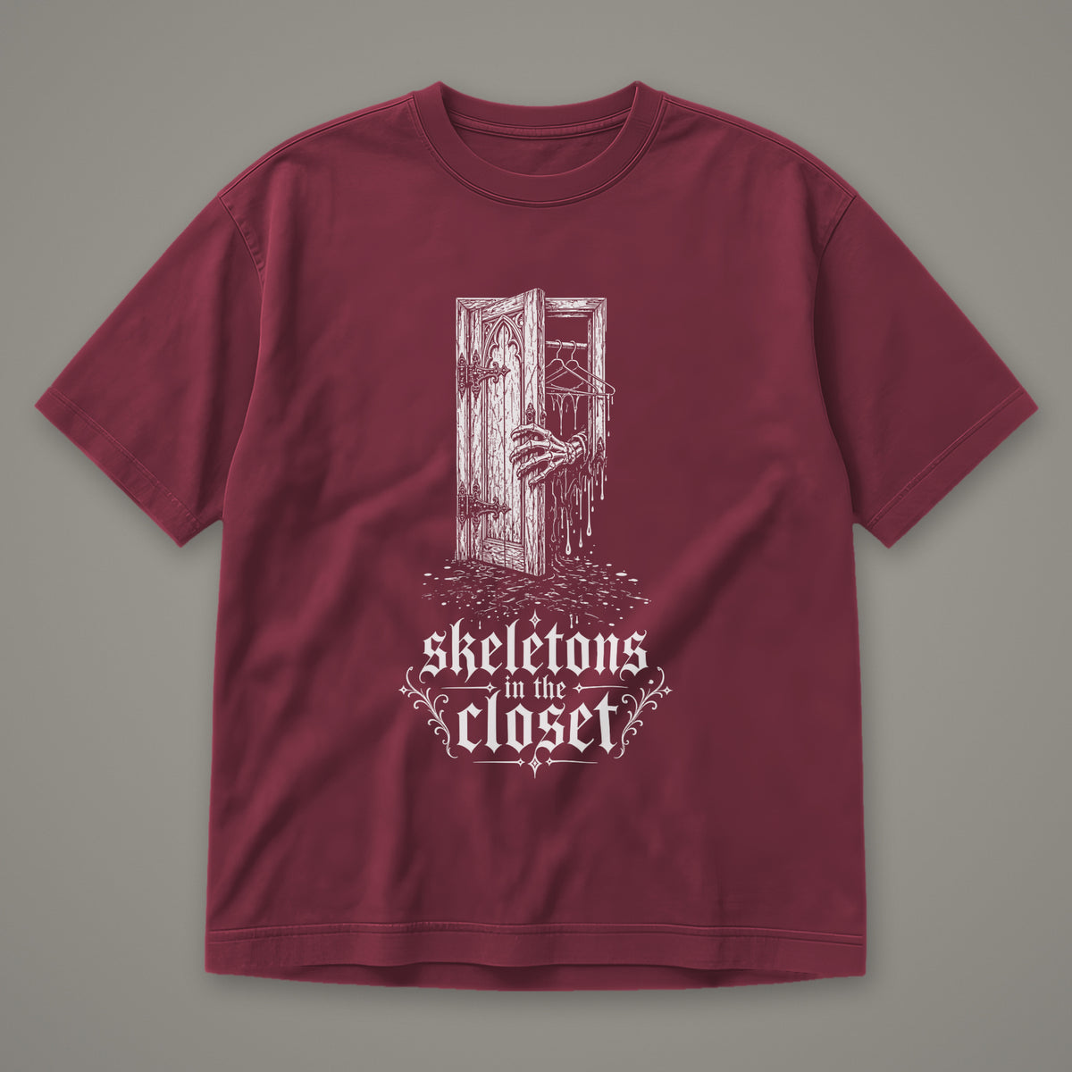Skeletons in the Closet Men's Heavyweight Tee in wine by Trauma Dump, skeleton hand in a closet door tattoo-style gothic graphic in white ink (Wine, white ink)