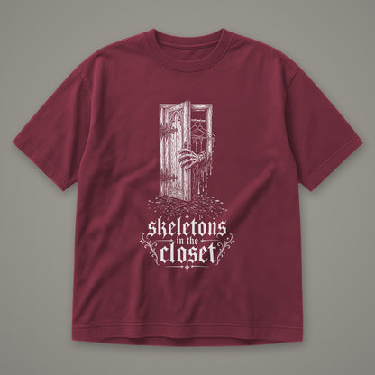 Skeletons in the Closet Men's Heavyweight Tee in wine by Trauma Dump, skeleton hand in a closet door tattoo-style gothic graphic in white ink (Wine, white ink)