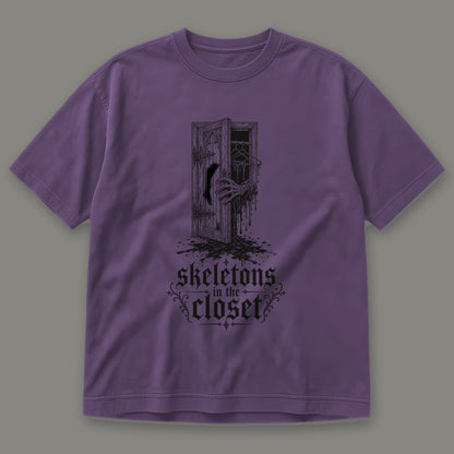 Skeletons in the Closet Men's Heavyweight Tee in grape by Trauma Dump, skeleton hand in a closet door tattoo-style gothic graphic in black ink (Grape, black ink)