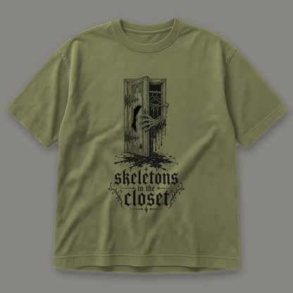 Skeletons in the Closet Men's Heavyweight Tee in moss by Trauma Dump, skeleton hand in a closet door tattoo-style gothic graphic in black ink (Moss, black ink)