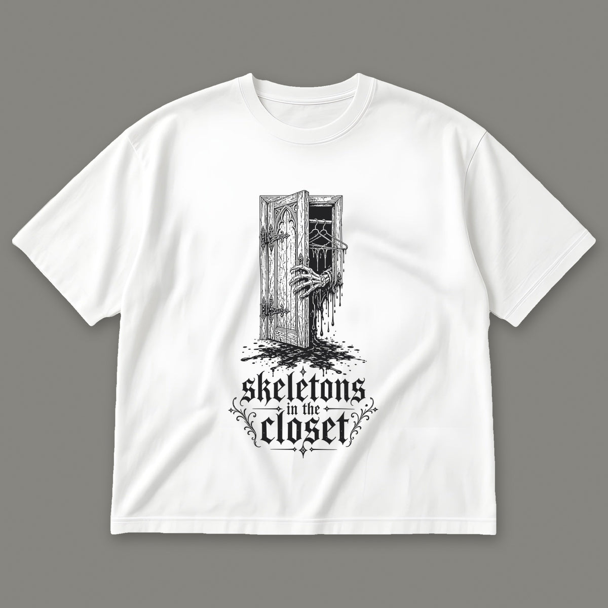 Skeletons in the Closet Men's Oversized Tee in white by Trauma Dump, skeleton hand in a closet door tattoo-style gothic graphic in black ink