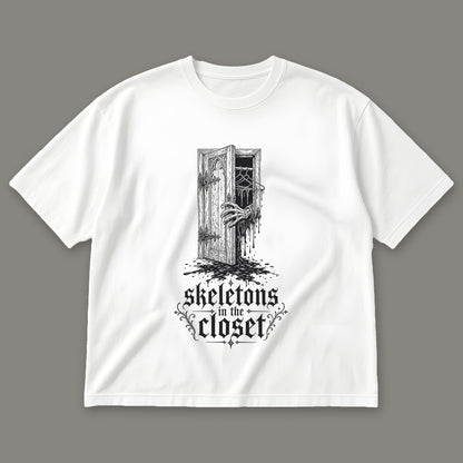 Skeletons in the Closet Men's Oversized Tee in white by Trauma Dump, skeleton hand in a closet door tattoo-style gothic graphic in black ink