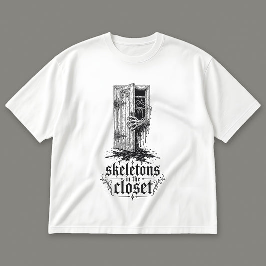 Skeletons in the Closet Men's Oversized Tee in white by Trauma Dump, skeleton hand in a closet door tattoo-style gothic graphic in black ink