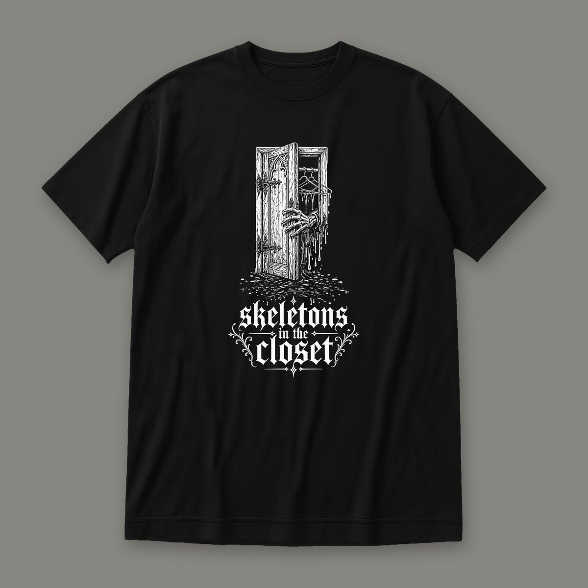 Skeletons in the Closet Women's Relaxed Tee in black by Trauma Dump, skeleton hand in a closet door tattoo-style gothic graphic in white ink (Black, white ink)