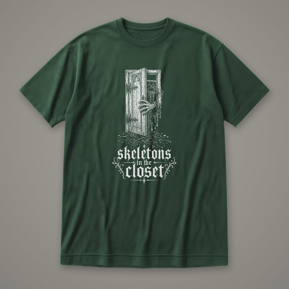 Skeletons in the Closet Women's Relaxed Tee in forest green by Trauma Dump, skeleton hand in a closet door tattoo-style gothic graphic in white ink (Forest Green, white ink)