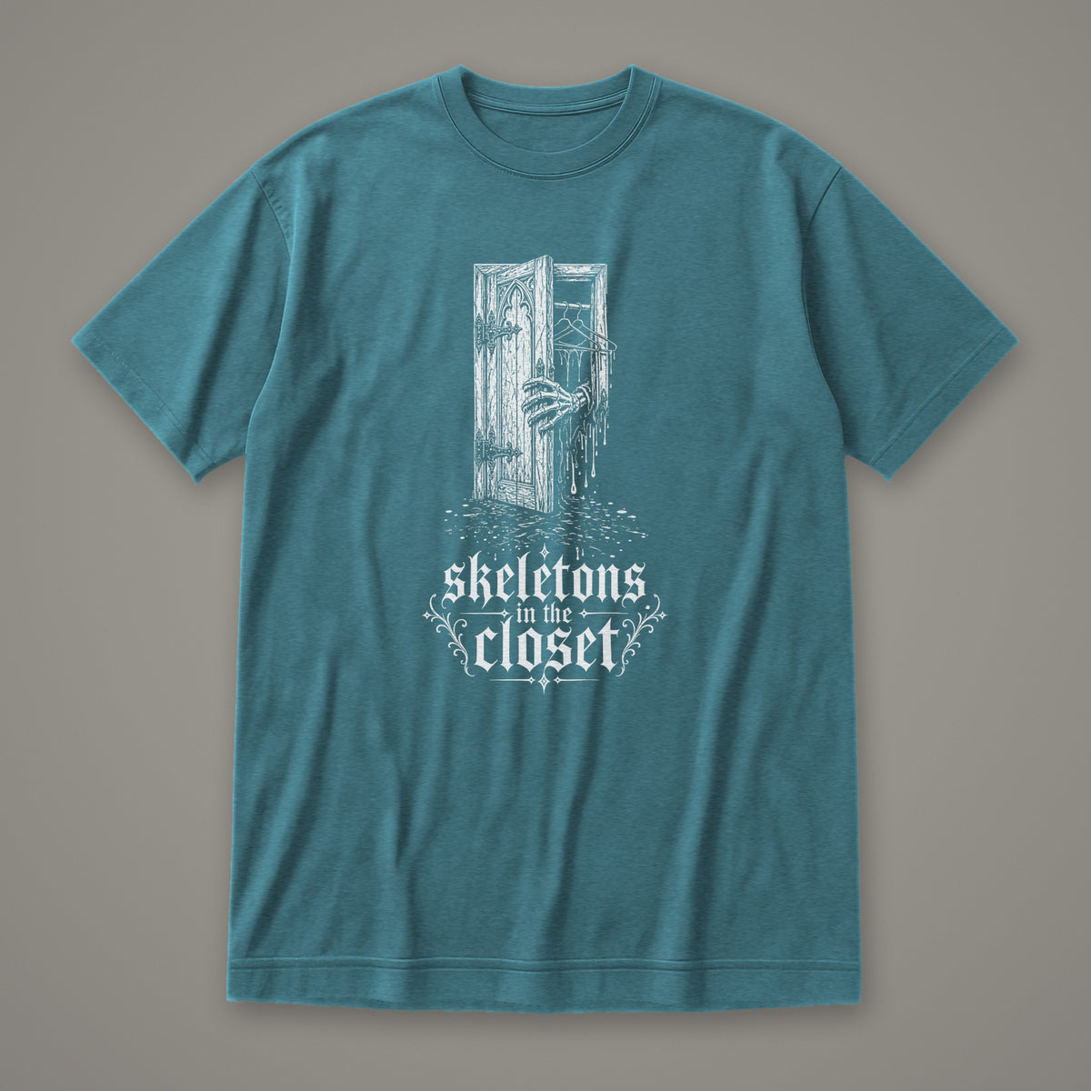 Skeletons in the Closet Women's Relaxed Tee in heather deep teal by Trauma Dump, skeleton hand in a closet door tattoo-style gothic graphic in white ink (Heather Deep Teal, white ink)