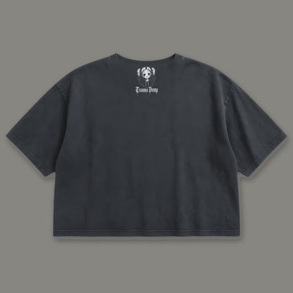 Trauma Dump Cropped Baby Tee in black, back view with doll portrait logo under the collar