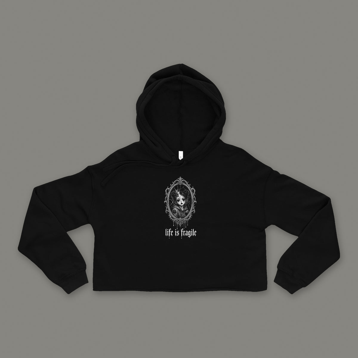 Life is Fragile Cropped Hoodie by Trauma Dump, black goth cropped hoodie front with cracked-mirror print, mockup view 3 (Black, white ink)