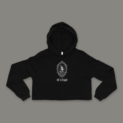 Life is Fragile Cropped Hoodie by Trauma Dump, black goth cropped hoodie front with cracked-mirror print, mockup view 3 (Black, white ink)